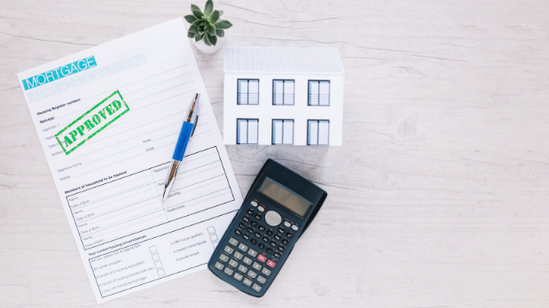 Veteran reviewing VA loan rates in Texas with mortgage documents and calculator on a desk